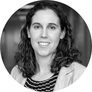 white woman with mid-length curly brown hair