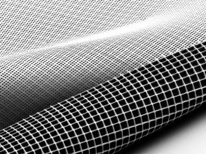 This electron microscope image of the new “scaffolding” for growing and implanting retinal cells shows the ice cube tray-shaped reservoirs that hold cells and cylinder-shaped holes in the bottom layer, which provide channels for maturing photoreceptors to make contact with a patient’s retinal tissue. COURTESY OF THE MA LAB