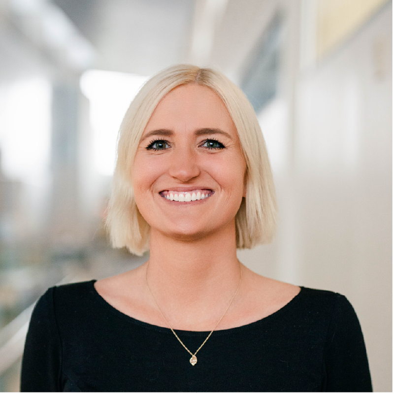 headshot of a white woman with a white blond bob