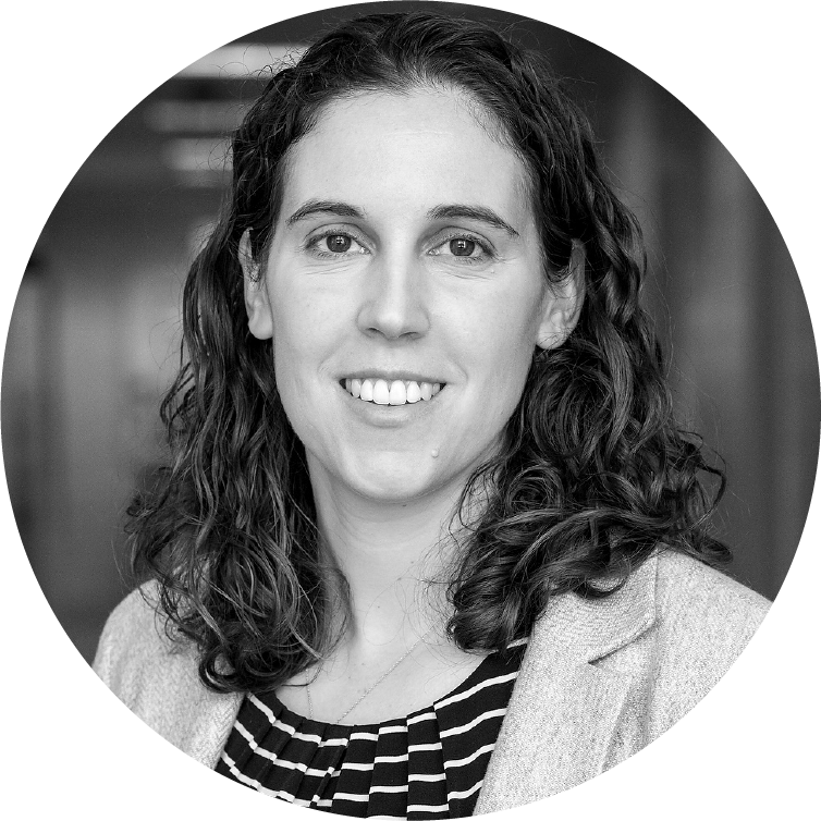 white woman with mid-length curly brown hair
