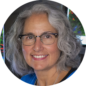headshot of a woman with a gray bob and glasses
