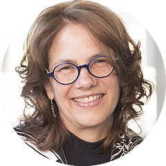 headshot of a white woman with long brown hair and glasses