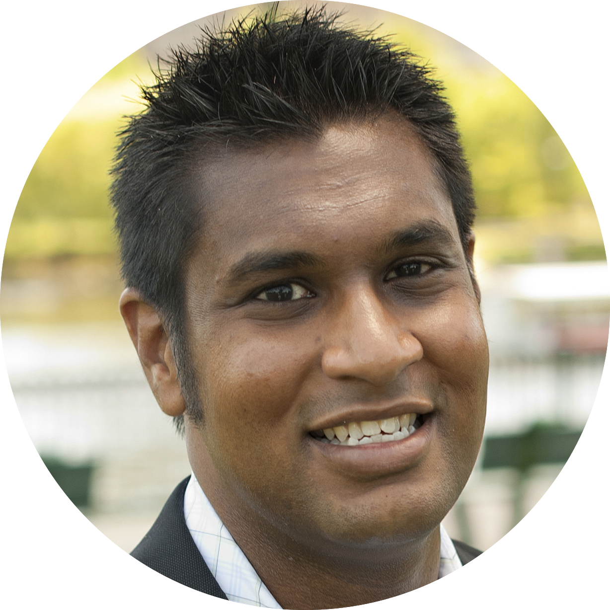 headshot of a south asian man with short black hair
