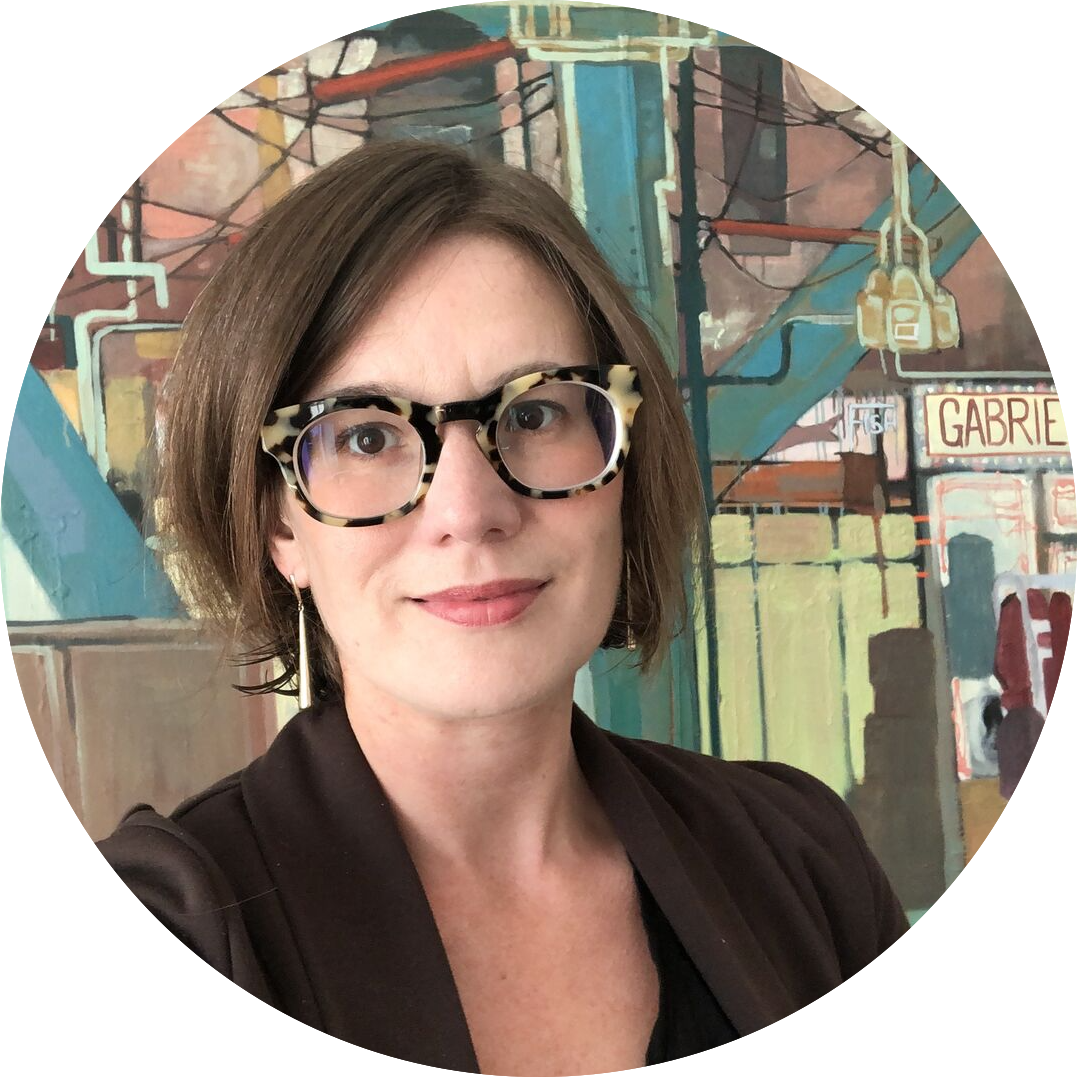 headshot of a white woman with short brown hair and glasses