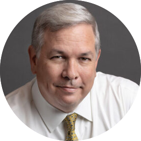 headshot of a white man with short gray hair